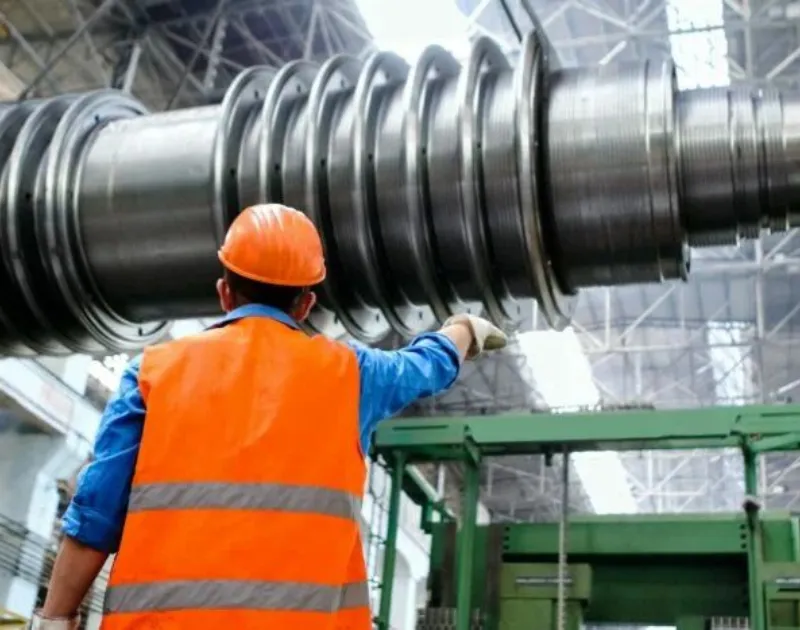 Engineer checking a machine in a manufacturing plant