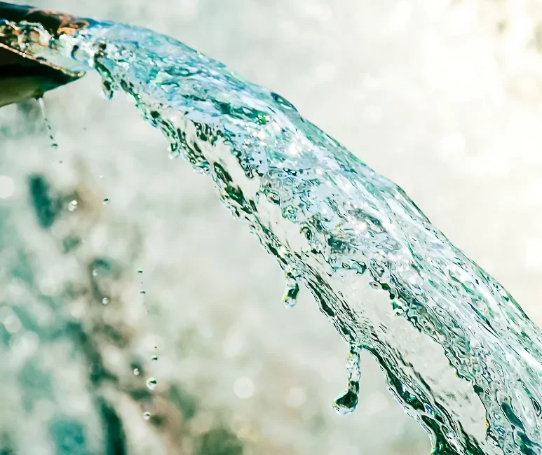 Close up of water gushing out of the pipe