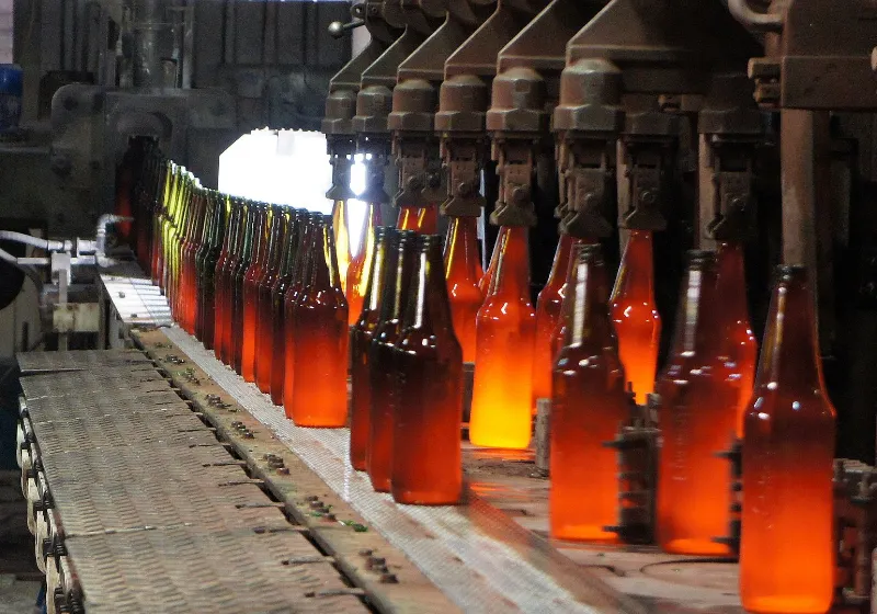 Hot bottles in a conveyor in a factory