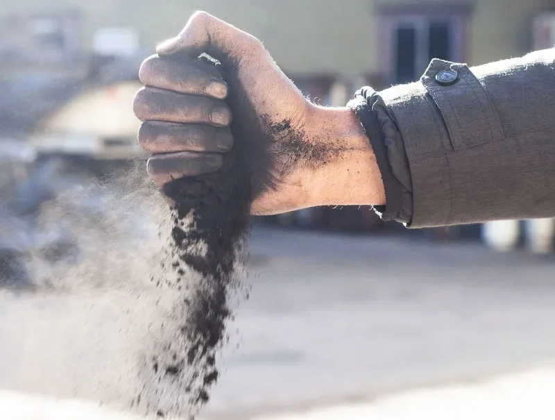 Man holding a powdered charcoal